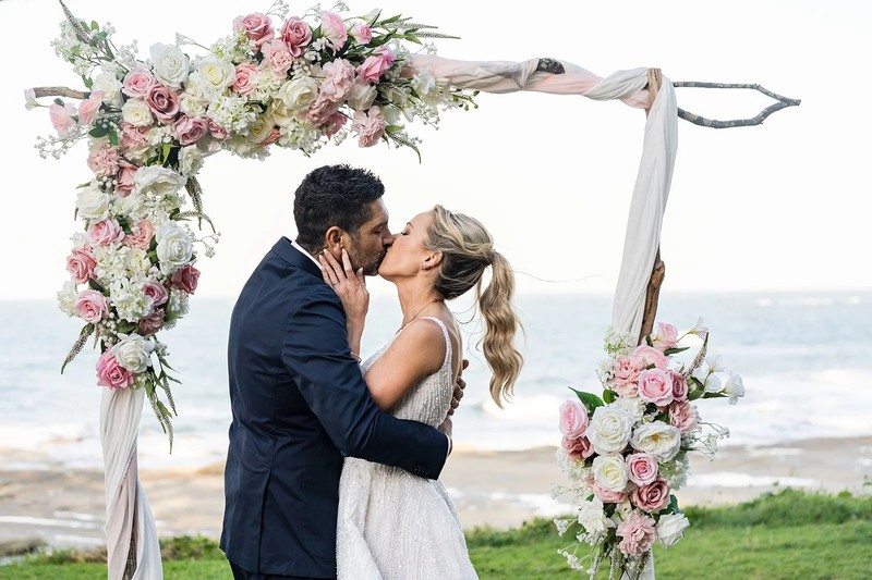 Bride and groom sharing a kiss at the waterline on Clearwater Beach during sunset