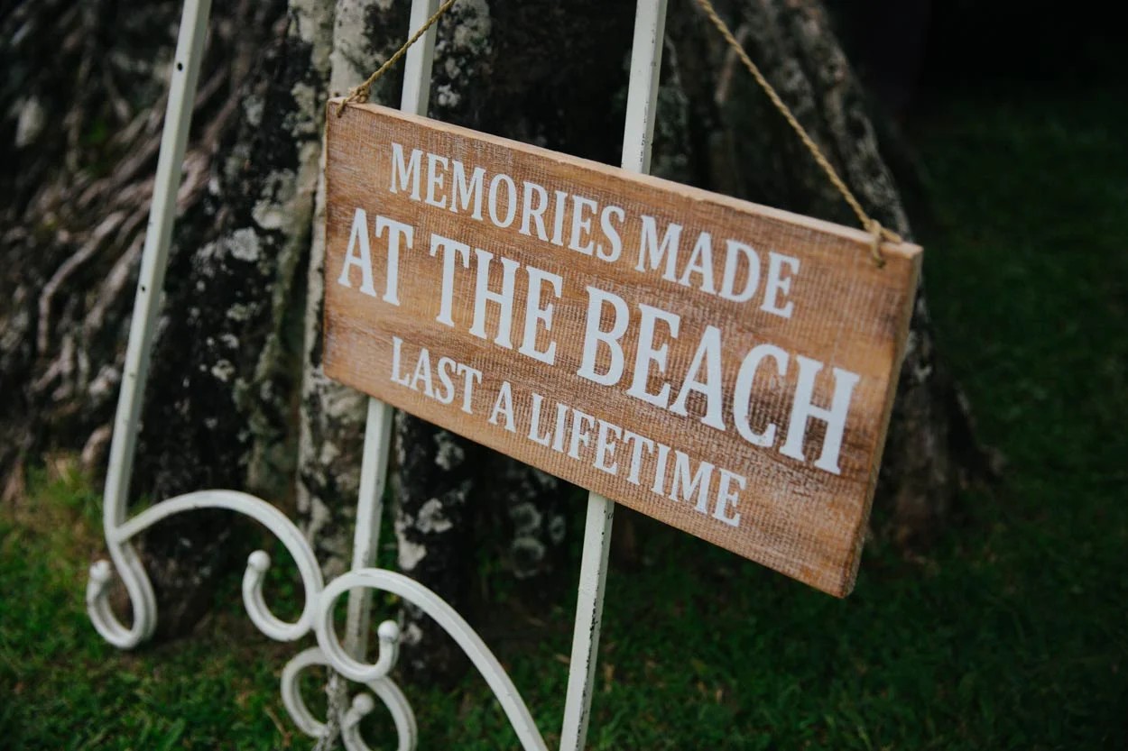 Bride and groom walking along Siesta Key shoreline after their beach wedding